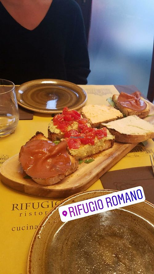 mixed Bruschetta plate with hummus, different spreads and vegan ham, it was amazing! at Rifugio Romano in Rome