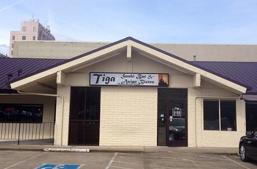 Restaurant front and parking lot at Tiga Sushi and Asian Bistro in Salem