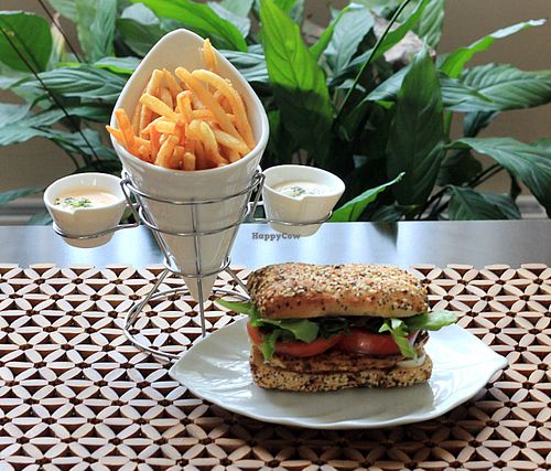 VegNature Vromage in a bagelwich with tofu "chicken", tomatoes, spinaches, mesclun and vegenaise with French fries and 2 sauces (a mild one and a spicy one). at VegNature Nancy Grenier in Quebec