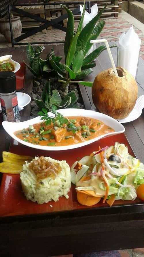 Pan seared Tofu with roasted pumpkin seeds, wedges of spring onions served with smashed sweet potato with an onion confit and salad at Kind Earth Eatery in Dar Es Salaam