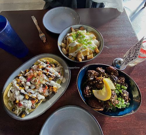 Loaded potatoes, guacamole tostadas, and Szechuan Brussels sprouts  at Graze in Nashville
