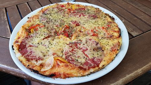 Vegan pizza with 'sausages' and 'cheese' at Punkt 13:15 in Parnu