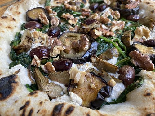 Spinach pizza with extra toppings   at La Stella Nera in Berlin