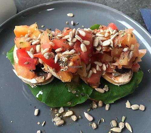 Toast with mushroom slices, tomato, fresh herbs and sunflower seed at Joe's Place in Pico