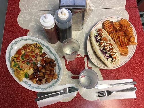 Western omelet and Buffalo chicken sandwich with waffle fries. at The Tasty in Philadelphia