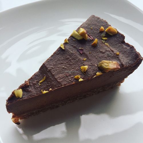 chocolate and chaga cake sprinkled with pistachios  at Juice Warrior in Edinburgh