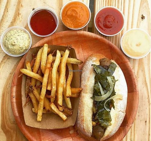 vegan sausage on Guglhupf bun, topped with Pickled Collard Greens, Spicy Peppers, Carmelized Onions, Mustard. Side of fries with various vegan sauces. at Black Twig Cider House in Durham