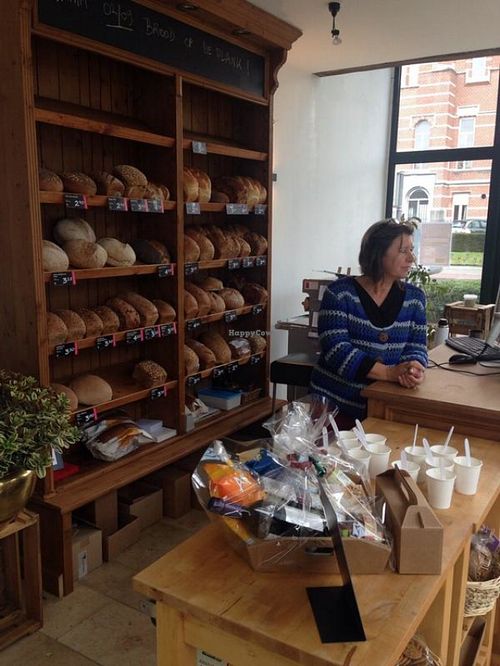 bread section and register at Happy Food Store in Schoten