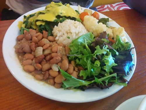 Full plate; mixed salad with basil lemon agave dressing, short grain brown rice, pinto beans with onion and garlic, collard greens with shiitake squash sauce, sautéed cauliflower, broccoli, carrots, zucchini.  at Shangri-La Vegan - Telegraph in Oakland