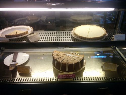Dessert case. Raw pies, strawberry & coconut, chocolate mousse cake at Shangri-La Vegan - Telegraph in Oakland
