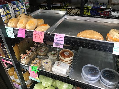 Reverie Kolache, empanada, cheese biscuit and chocolate peanut butter cups, and Goats Revolt cheeses at Farmers Market of Grapevine in Grapevine