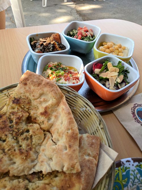 5 salad tasting - hummus, bababganous, beet salad, tabbouleh, and sweet potato lentil salad with zatar bread  at Umm Kulthum in Haifa