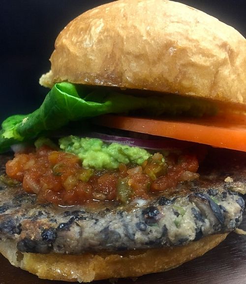 Garden Earth Burger.  Lentils, hemp, chia, pumpkin seeds, grains, veggies, spice. topped with house made salsa, guacamole, romaine and tomato on a brioche bun.  at Guernsey Kitchen in Cambridge