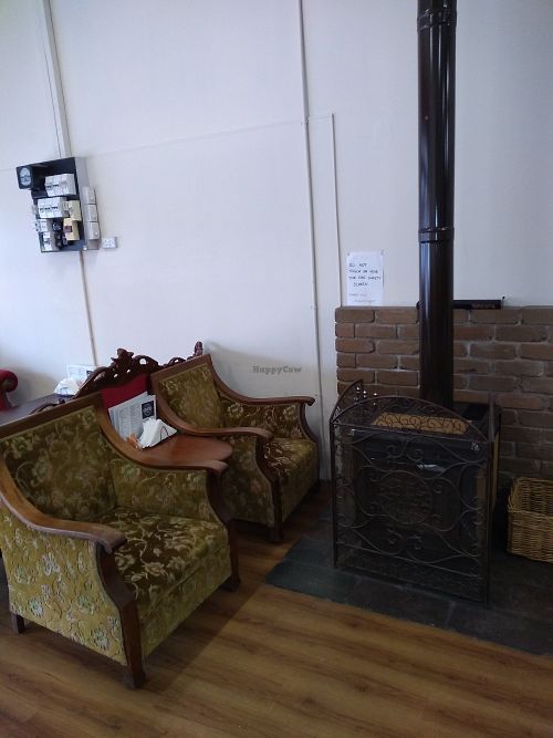 Cosy spot by the fire at The Whistling Cat in Mount Gambier