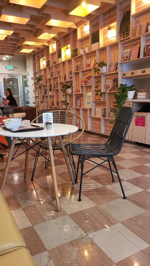 Indoor seating, community table at Manna Life Food in Miami