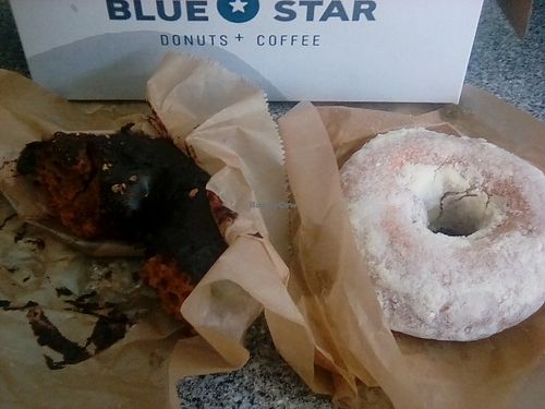 Tasty chocolate donut with chocolate icing... Lemon cake donut topped with powdered sugar topping. Bought at Portland airport location, moist & tasty even after 2 hour flight. at Blue Star Donuts - 23rd in Portland