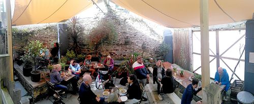 Courtyard garden with retractable sail canopy. at Sprout Health Foods in Newquay