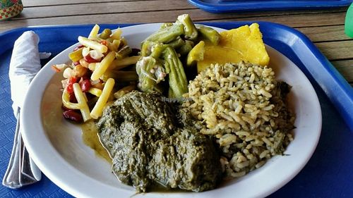 My lunch from top: okra, cou cou, rice with calaloo, calaloo, 3 bean salad. at Creole Shack in St Georges