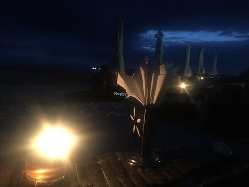 Table in the sand with candles  at Mowie's  in 
