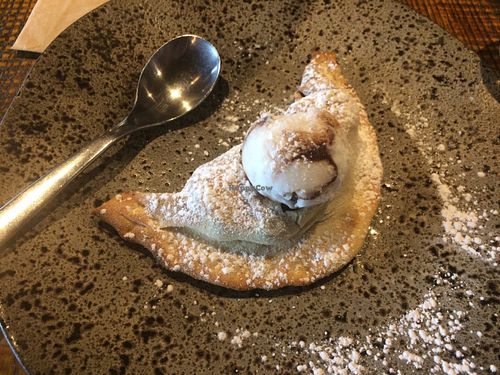 Vegan dessert calzone, filled with bananas, pecans and blueberries, topped with coconut & chocolate ripple ice cream at Zizzi - Bankside in South East London