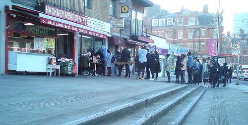Sunday morning worshipers waiting in line. at Temple of Seitan - Hackney in East London