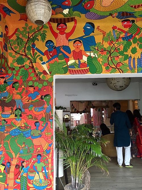Beautiful space with lots of art and varied seating (tables, floor cushions). at Jatra Biroti in Dhaka