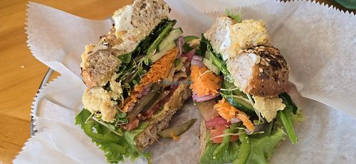 "Hummus and all the Veggies" on a toasted While Wheat  w/Italian Seasonings Bagel which had to be remade because it got cut with a knife that left cream cheese smear on vegan orde at Bagel Cafe in Camden