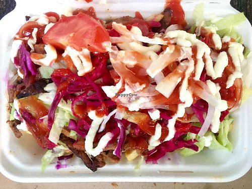 The Doner kebab and chips in a box covered with salad and sauces at What The Pitta in London
