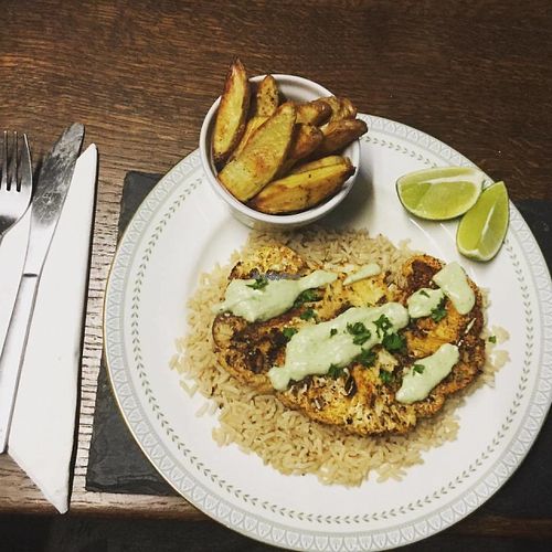 Cajun Cauiflower "Steak" on a bed of Brown Rice with a delicious creamy Avocado Sauce at The Hidden Veggie Kitchen in Limoges