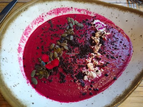 Vegan gazpacho with raspberry, olive powder, crumbled tofu, and pepitas. at Gusto Ristobar in Sevilla