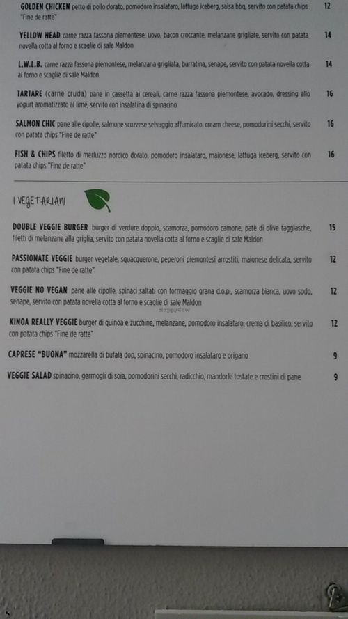 the menu outside the restaurant with a clear mark of vegetarian/vegan options at Fatto Bene Burger in Milan