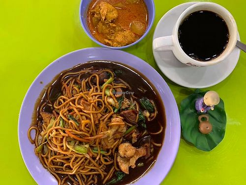 Hokkien Mee with a small bowl of curry and coffee black 
Photo credit to Henry Lau at Happy Vegetarian - Ang Mo Kio in Northeast Singapore