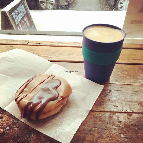 PB&J and chocolate drizzle doughnut with oat milk latte  at Dun-Well Doughnuts in New York City