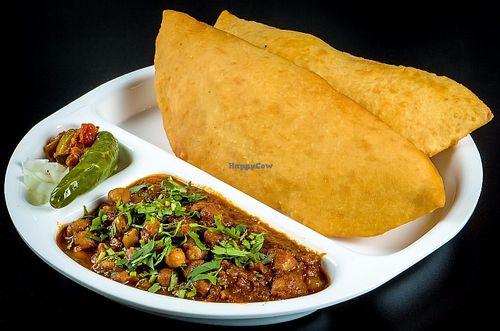 Falten Bread Made With All Purpose Flour and mixture 
( Contain Milk ) ...but can be substituted with poori instead 
Served With Garbanzo Beans Curry  at Chowpatty Express in Katy