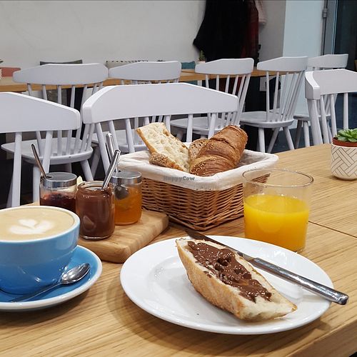 Breakfast - a basket of bread with chocolate spread and jams, a croissant, freshly squeezed orange juice and coffee at Cloud Cakes - Mandar in Paris