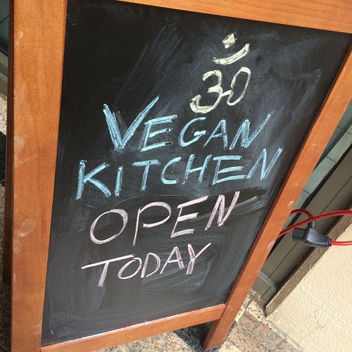 Sign out front at OM Vegan Kitchen in Surry Hills