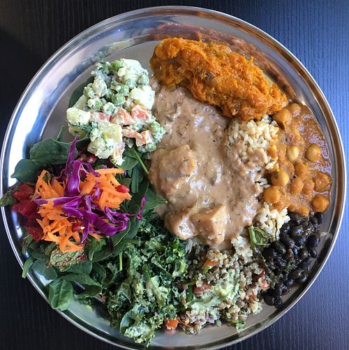 brown rice, pumpkin, chickpea curry, mushroom stroganoff, black bean stew, lentil and quinoa tabouli, spinach, carrot, purple cabbage, pomegranate, potato's peas and carrots! YUM. at OM Vegan Kitchen in Surry Hills