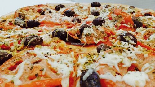 Specifically named vegan pizza has olives, oregano, fresh tomato and vegan cheese at Allambie Pizza Shop in Allambie Heights