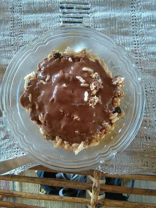 delicious mango bowl with granola and chocolate sauce at Dharma Swasti in Kuilapalayam