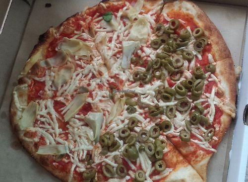 Half artichoke hearts, half green olive, vegan pizza. at Pizza Fire in Kettering