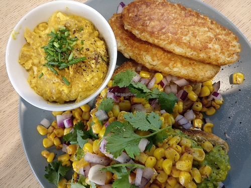 Avocado with chipotle grilled corn and coriander, with a side of scrambled tofu and hash browns.  at Wombat Cafe & Store in Dromana