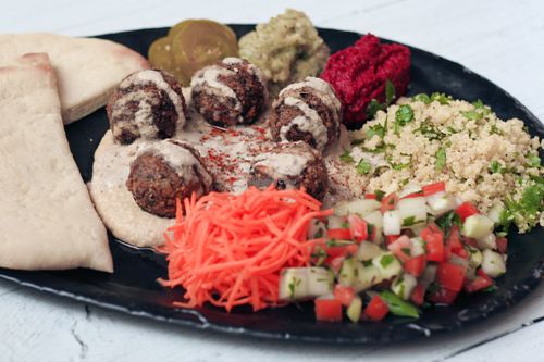 Middle Eastern Mezze - falafel, hummus, muhummara, babaganoush, salads, pickles and fluffy homebaked pita bread at Nourish Cafe in Yangon