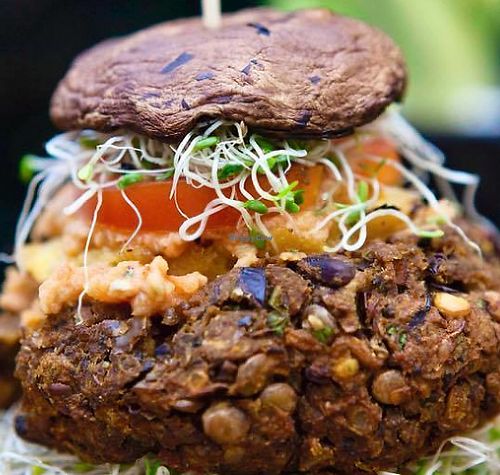 Wholey's bigger than bun burger! Pumpkin+black bean+lentil patty top with portobello mushroom+sprout+grilled pineapple+tomato with our eggplant/sundried tomato spread. All home made with love.  at Wholey Wonder in Penang