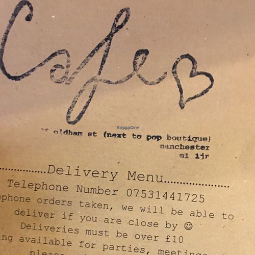 front of menu  at Nibble Cafe in Manchester