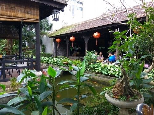 Eating areas and pond at Ngu Ha Garden Vegetarian Restaurant in Hue