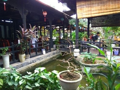 Eating areas and pond at Ngu Ha Garden Vegetarian Restaurant in Hue