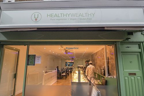 From outside the Restaurant shines with a Golden light and the food fragrance pervades the Street! at HealthyWealthy in North London