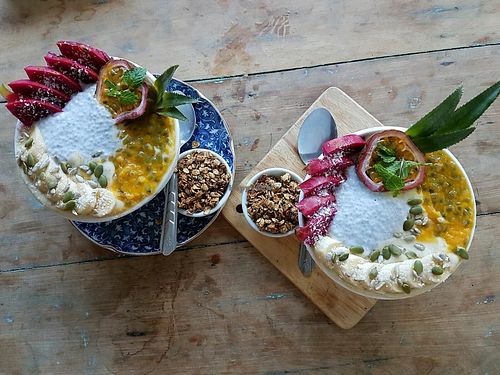 mango smoothie bowls with a side of crunchy granola :)  at Peace Food Cafe in Sihanoukville