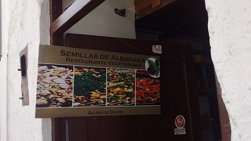Sign in doorway at Semillas de Albahaca in Tunja