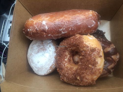 Box of donuts with bear claw, powdered donut and others at Vegan Donut Gelato - Modesto in Modesto